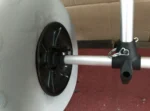 Closeup of canoe trolley wheel quick release axle pin and mounting hardware detail