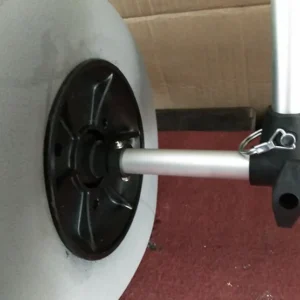 Closeup of canoe trolley wheel quick release axle pin and mounting hardware detail