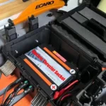 Internal view of IP68 waterproof kayak battery compartment with installed battery and power sockets