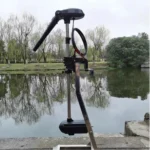 Front angle view of P300 brushless trolling motor mounted on a small boat in natural water environment