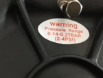 Closeup of kayak cart balloon wheel pressure warning sticker 0.14–0.27BAR 2–4 PSI